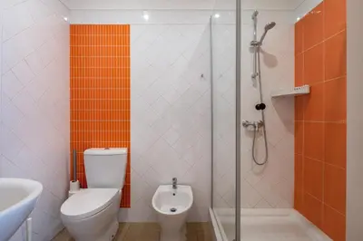 a bathroom with a shower and a toilet and a sink at Vita Portucale ! Quarteira Sea View in Quarteira