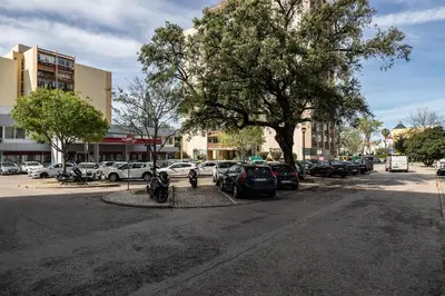 a street with cars parked in a parking lot at T0 Vilamoura Downtown in Vilamoura