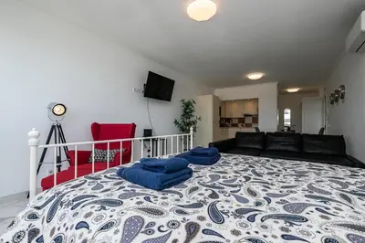 a bedroom with a large bed with blue towels on it at T0 Vilamoura Downtown in Vilamoura