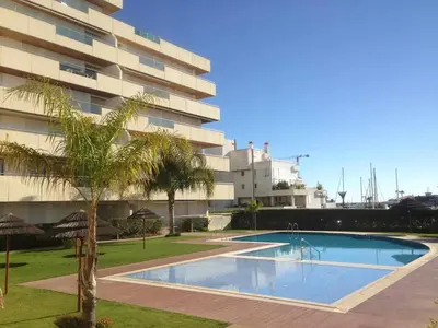 a large swimming pool in front of a building at Marina Vilamoura - Aquamar 320 by Vilamoura Sun in Vilamoura