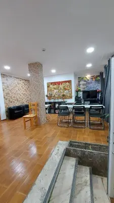 a living room with a couch and a table and chairs at Residencial Condado in Faro