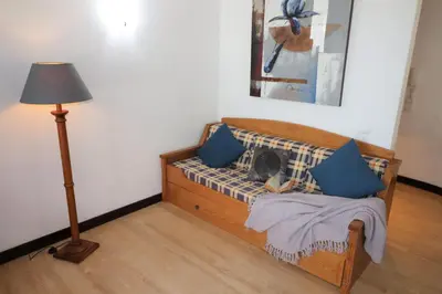 a bedroom with a bed with blue pillows and a lamp at Santa Eulalia Mar in Albufeira