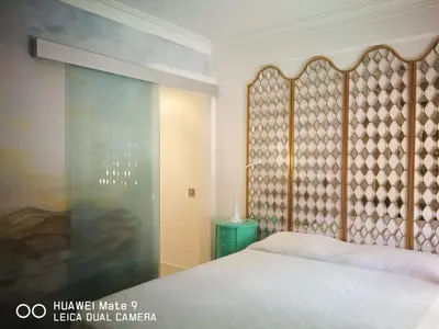 a bedroom with a bed and a glass wall at Atlântida T1 in Cavacos