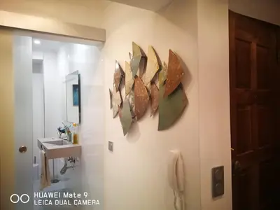 a bathroom with a sink and four mirrors on the wall at Atlântida T1 in Cavacos
