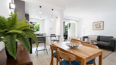 a living room with a table and a dining room at Vale do Lobo - Casa de La Rosa in Vale do Lobo