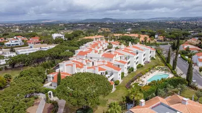 an aerial view of a large white building with orange roofs at Vale do Lobo - Casa de La Rosa in Vale do Lobo