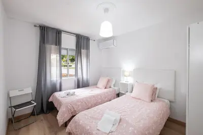 a bedroom with two beds and a window at #002 Donalds Flat by Home Holidays in Albufeira