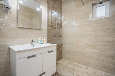 a bathroom with a sink and a shower at #002 Donalds Flat by Home Holidays in Albufeira