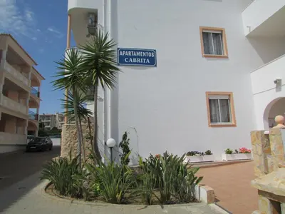 a street sign on the side of a building at Apartamentos Cabrita in Albufeira