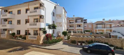 a car parked in front of a building at Apartamentos Cabrita in Albufeira