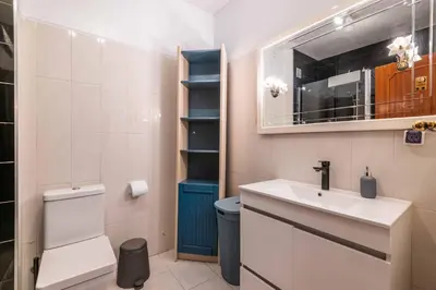 a bathroom with a sink and a toilet and a mirror at Casa Cerro Branco in Albufeira