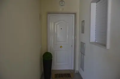 a hallway with a white door and a potted plant at Balcony View Albufeira in Albufeira