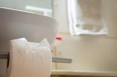 a roll of toilet paper on the back of a chair at Apartments near Marina de Vilamoura in Quarteira