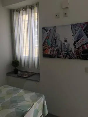 a bedroom with a bed and a picture on the wall at Casa Da Baixa in Faro