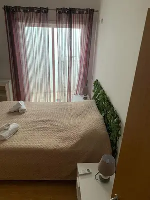 a bedroom with a large bed and a window at Casa Da Baixa in Faro