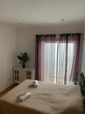 a bedroom with a bed with two towels on it at Casa Da Baixa in Faro