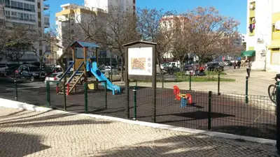 a playground with a slide in a park at Dunas 3- Elegante, 150mt Praia, Wifi in Quarteira