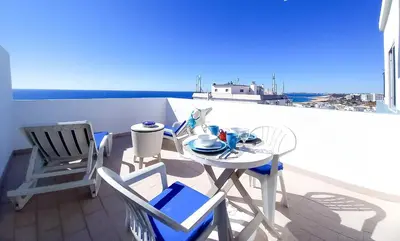 a table and chairs on a balcony with a view of the ocean at Mira Atlântico 13- Terraço Com Vista Mar e Cidade, Wifi, 80mt Praia in Quarteira