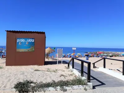 a sign on a beach with the ocean in the background at Pontemira 5 Esplêndido in Quarteira