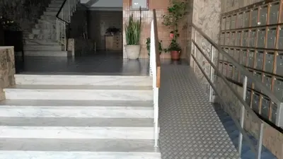 a stairway in a building with steps and a stair railing at Torre Azul 11 Vista Panoramica in Quarteira