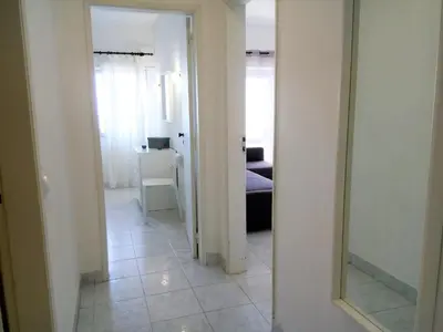 a hallway with a mirror and a living room at TORRE 14 Vista Magnifica in Quarteira