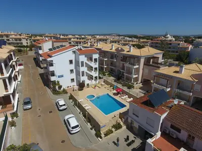 an aerial view of a city with a swimming pool at Apartamentos Cabrita in Olhos de Água