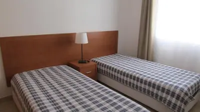 two beds sitting next to each other in a room at Apartamentos Cabrita in Olhos de Água