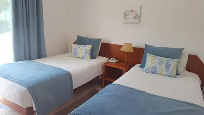 a room with two beds with blue and white at Mira Parque in Albufeira