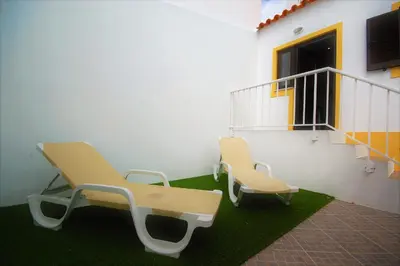 two chairs and a bench in a room with a staircase at Vila Baltum - Free private parking - Wifi - Airco # by bedzy # in Albufeira