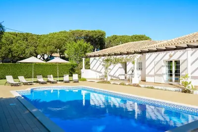a swimming pool in front of a house at Exclusive Villa Toulouse with pool in Falesia Algarve in Albufeira