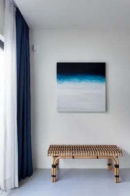 a bench in a room with a painting and a curtain at Casa Indigo- Perfect location & Sea View by DreamvillasAlbufeira in Albufeira