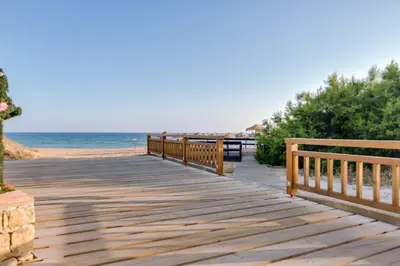 a wooden boardwalk leading to the beach at Villa V1 Vale do Lobo Beach in Vale do Lobo