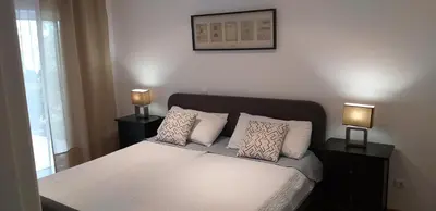a bedroom with a bed with two lamps on tables at FIND Your Space Casa no Campo - Paderne - Albufeira - Piscina Privada - Aquecida a pedido in Paderne