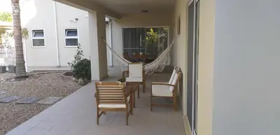 a porch with chairs and a table and a swing at FIND Your Space Casa no Campo - Paderne - Albufeira - Piscina Privada - Aquecida a pedido in Paderne