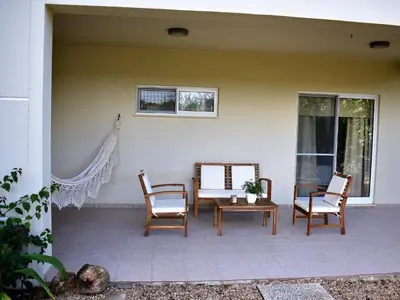 a patio with chairs and a table and a window at FIND Your Space Casa no Campo - Paderne - Albufeira - Piscina Privada - Aquecida a pedido in Paderne