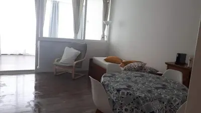 a room with a bed and a table and a window at Hello Chloé in Vilamoura