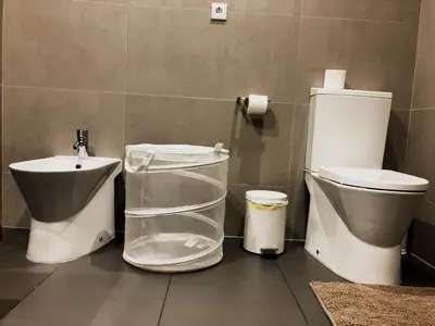 a bathroom with a toilet and a sink at Cavalo Preto Luxury Beach Resort - C201 in Quarteira