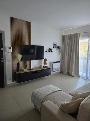 a living room with a flat screen tv and a couch at Cavalo Preto Luxury Beach Resort - C201 in Quarteira