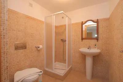 a bathroom with a shower and a toilet and a sink at Full private 300sqm Villa Jacuzzi Heated Pool Ideal & quiet location in Albufeira