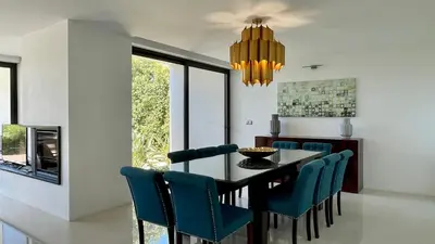 a dining room with a table and blue chairs at Passion by Check-in Portugal in Albufeira