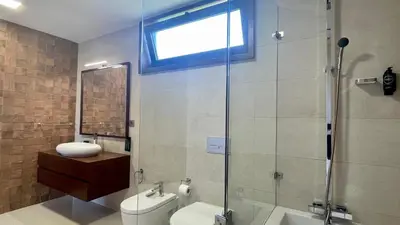 a bathroom with a shower and a toilet and a sink at Passion by Check-in Portugal in Albufeira