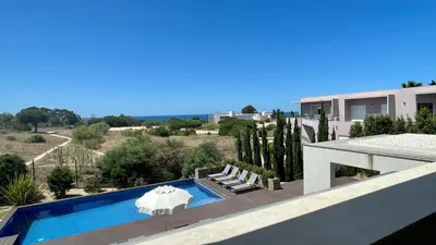 a villa with a swimming pool and a house at Passion by Check-in Portugal in Albufeira