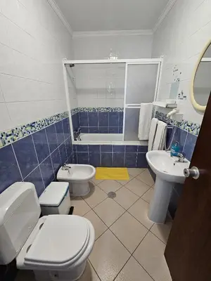 a bathroom with two toilets and a sink at Hotel Adelaide in Faro