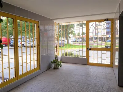 a room with doors and windows with a view of a street at Sol europa- Vista Mar, 150mt Praia, Wifi in Quarteira