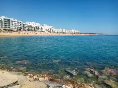 a view of a beach with buildings in the background at Sol europa- Vista Mar, 150mt Praia, Wifi in Quarteira