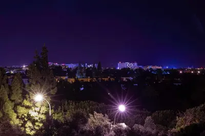 a view of a city at night with lights at Apartamento Vista Golfe Mar Vilamoura in Vilamoura