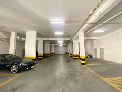 a parking garage with a black car parked in it at Apartamento Vista Golfe Mar Vilamoura in Vilamoura