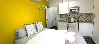 a small kitchen with a bed in a room at Sleep & Go Faro Airport Guest House in Faro