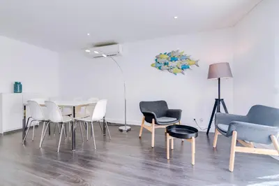 a room with chairs and a table and a lamp at AL - Apartamento Terracos da Falesia in Vilamoura