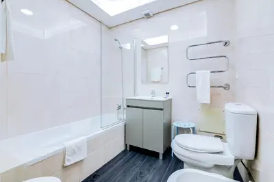 a white bathroom with a toilet and a sink at AL - Apartamento Terracos da Falesia in Vilamoura